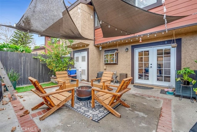 view of patio with french doors and a fire pit