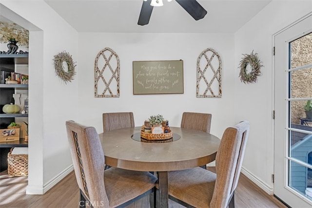 dining space featuring ceiling fan and hardwood / wood-style flooring