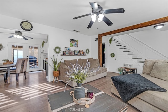 living room featuring ceiling fan, hardwood / wood-style floors, and french doors