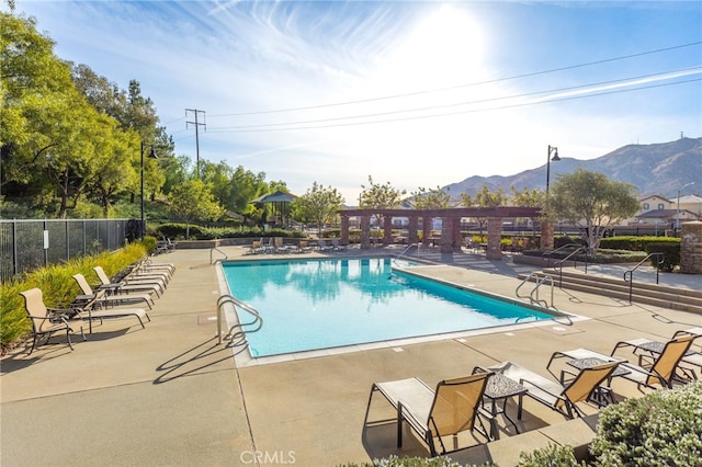 view of pool featuring a mountain view and a patio area