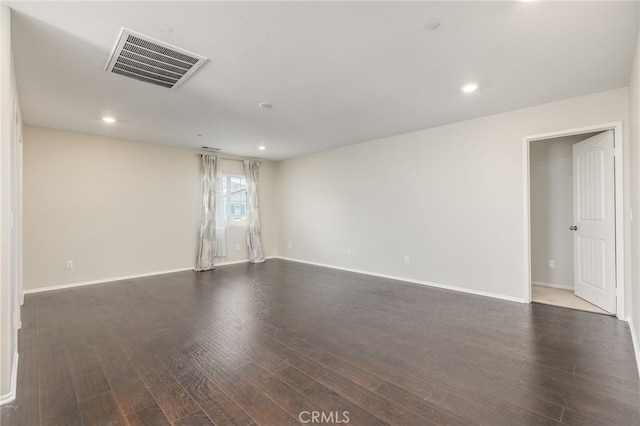 empty room featuring dark wood-type flooring