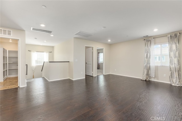 empty room with dark hardwood / wood-style flooring