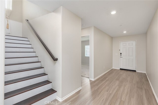 foyer entrance with light hardwood / wood-style floors