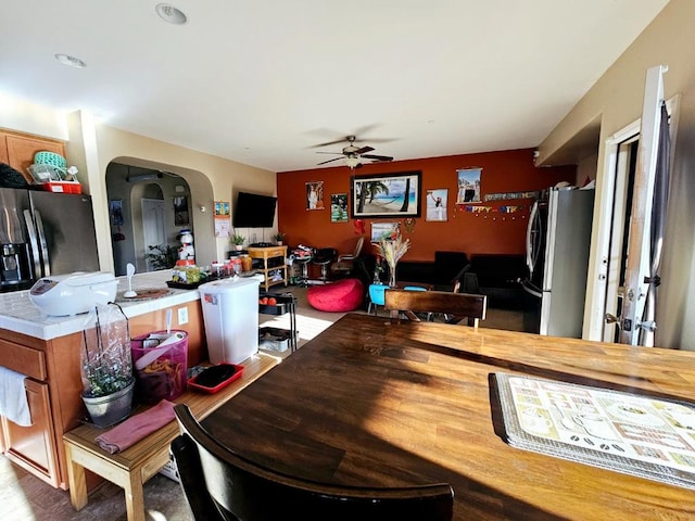 kitchen with ceiling fan, wood-type flooring, and stainless steel fridge