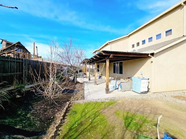 back of property with a pergola and a patio