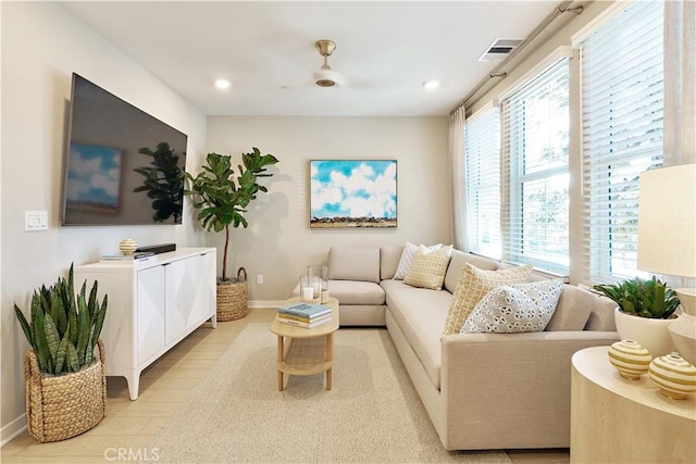 living room featuring ceiling fan and light wood-type flooring