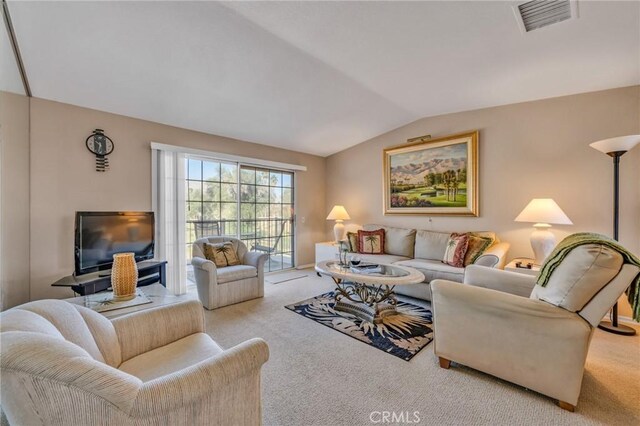 living room featuring light carpet and vaulted ceiling