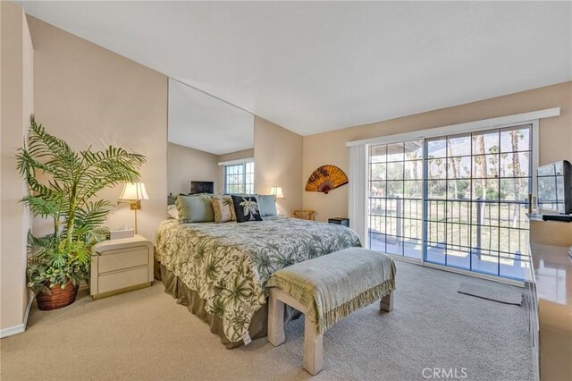 bedroom with access to exterior, multiple windows, lofted ceiling, and carpet