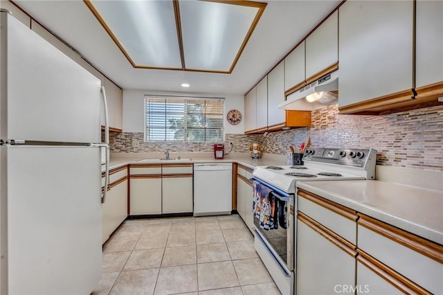 kitchen with white cabinetry, white appliances, light tile patterned floors, and tasteful backsplash