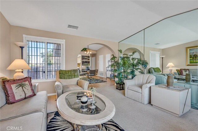 living room with ceiling fan and carpet