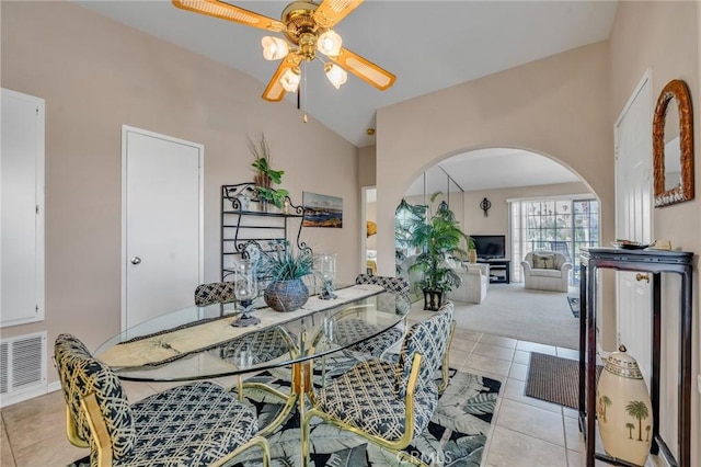 tiled dining room with ceiling fan and vaulted ceiling