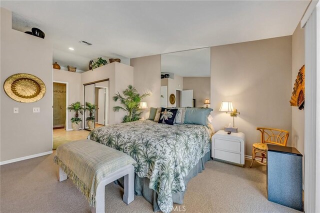 bedroom with light colored carpet and a closet