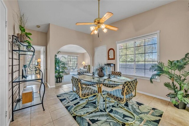 dining space featuring ceiling fan and light tile patterned flooring