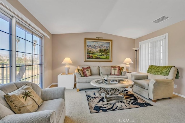 carpeted living room featuring vaulted ceiling