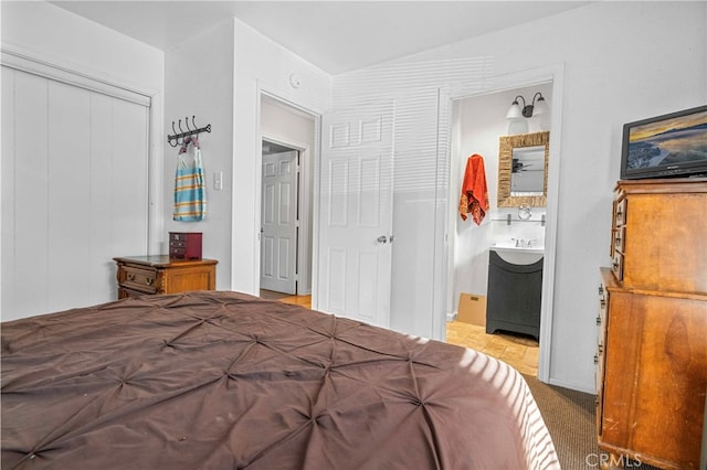 bedroom with carpet, a closet, and ensuite bathroom