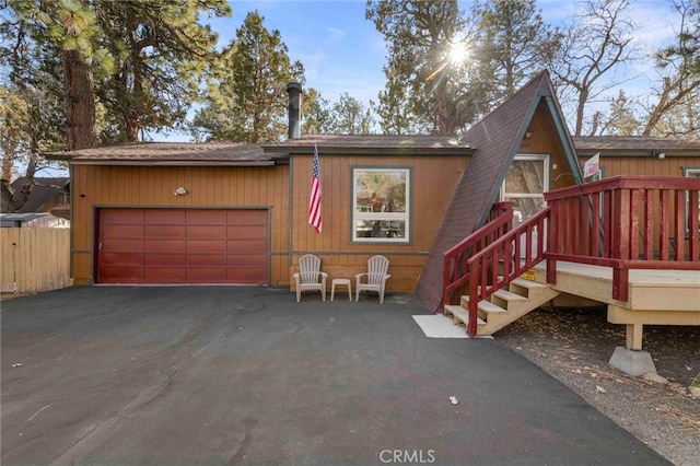 view of front of property with a garage and a deck