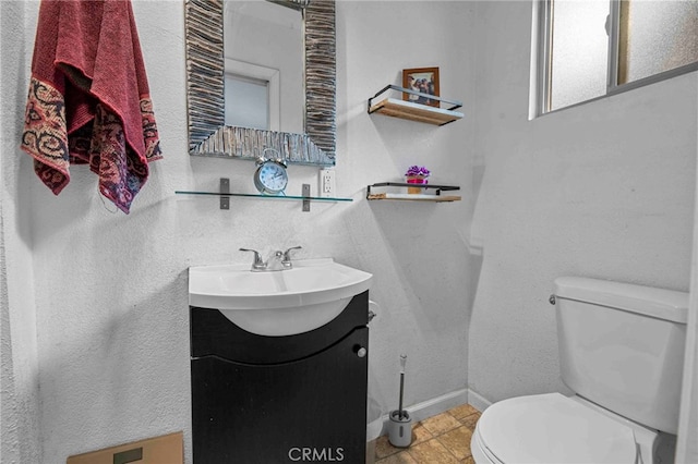 bathroom with tile patterned floors, toilet, and vanity