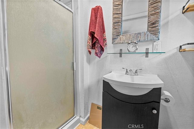 bathroom with an enclosed shower and vanity