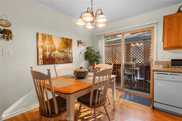 dining room with a chandelier and light hardwood / wood-style floors