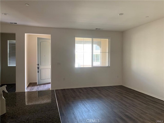 unfurnished room featuring dark hardwood / wood-style flooring