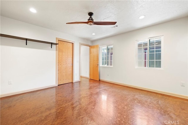 unfurnished bedroom with ceiling fan, a textured ceiling, and concrete floors