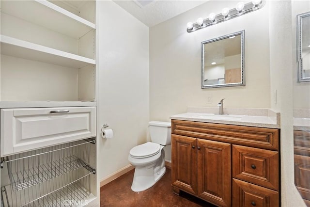 bathroom featuring toilet and vanity