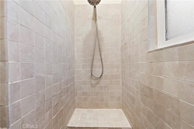 bathroom with a tile shower