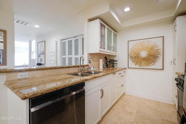 kitchen featuring decorative backsplash, dishwasher, white cabinets, light stone counters, and sink