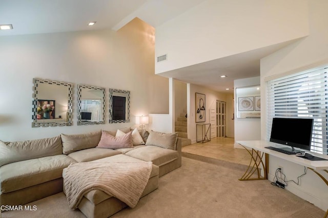 carpeted living room featuring high vaulted ceiling