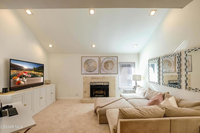 living room with light carpet, a tiled fireplace, and high vaulted ceiling