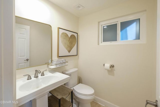 bathroom featuring toilet and sink