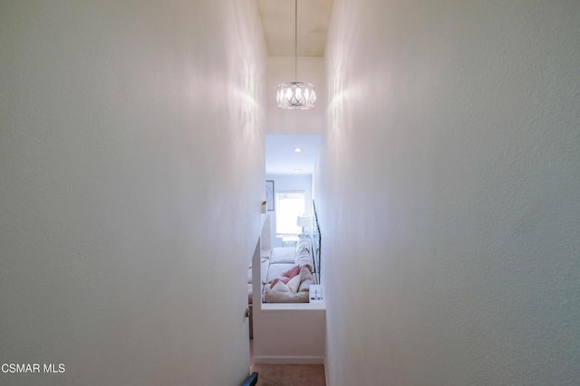 hallway with a notable chandelier