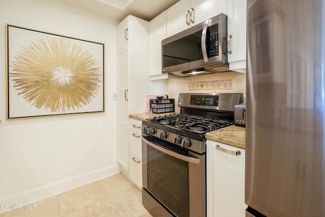 kitchen with tasteful backsplash, stainless steel appliances, and white cabinetry