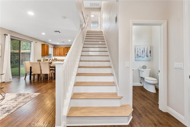 stairs with wood-type flooring