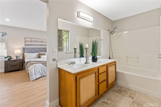 bathroom featuring bathtub / shower combination and vanity