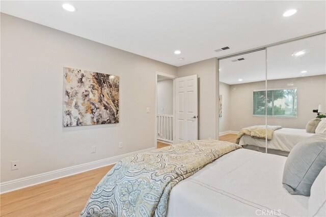 bedroom featuring hardwood / wood-style flooring and a closet