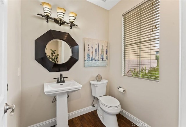 bathroom with toilet, hardwood / wood-style flooring, and sink