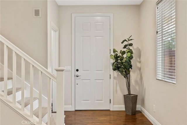 entryway with dark hardwood / wood-style flooring