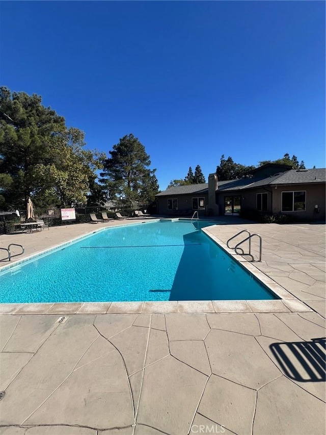 view of swimming pool with a patio area