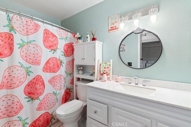 bathroom featuring toilet, walk in shower, and vanity