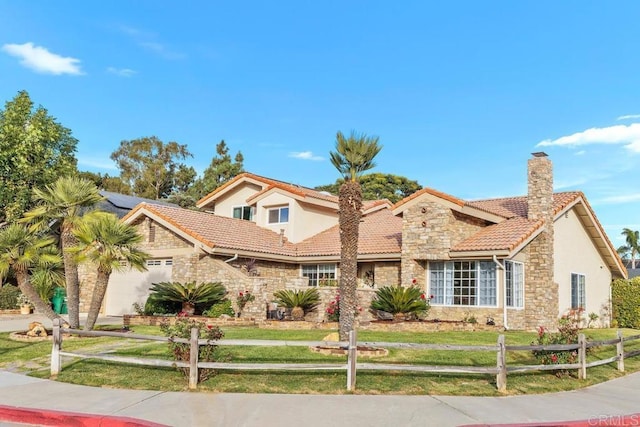 mediterranean / spanish house featuring a front lawn and a garage