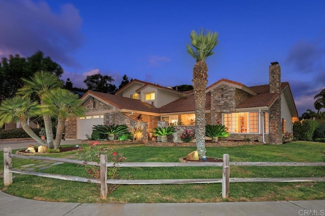 view of front of home featuring a lawn and a garage