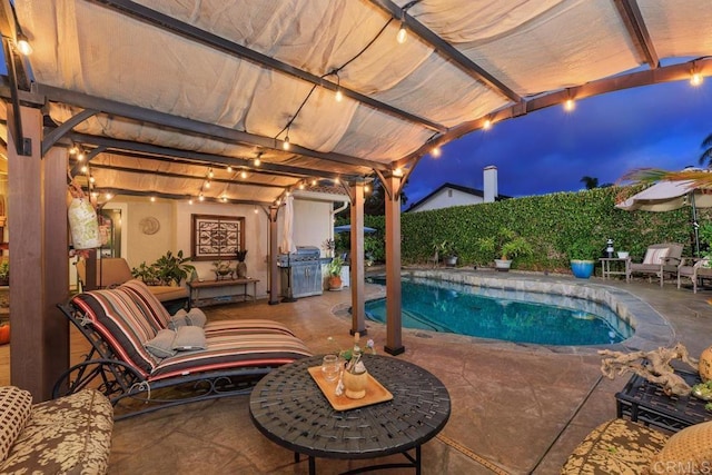 view of pool featuring grilling area, a patio, and an outdoor living space