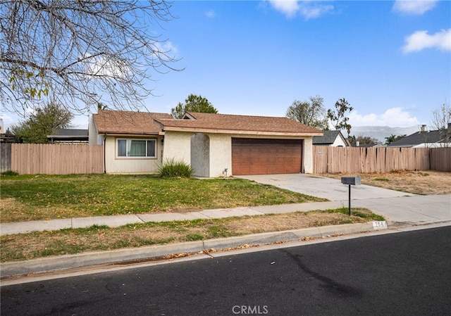 ranch-style home with a garage and a front yard