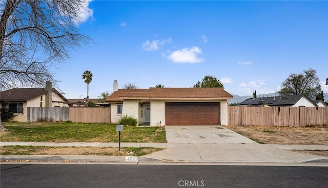 single story home featuring a front yard and a garage