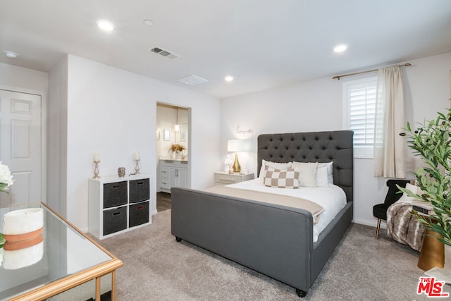 carpeted bedroom with connected bathroom