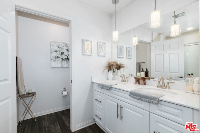 bathroom featuring an enclosed shower, vanity, and wood-type flooring