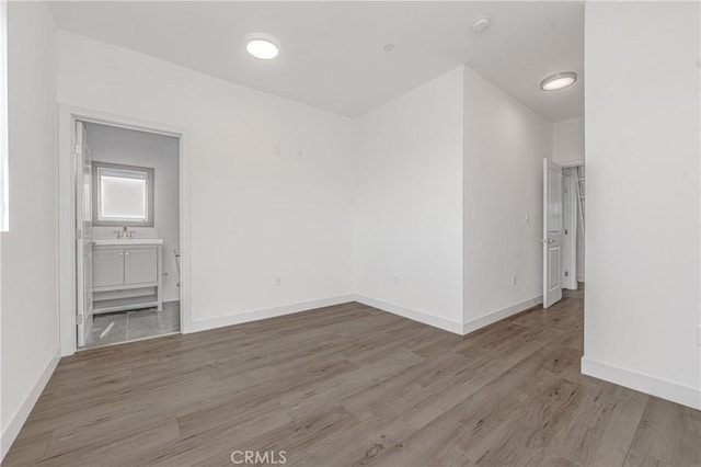 spare room with light hardwood / wood-style flooring