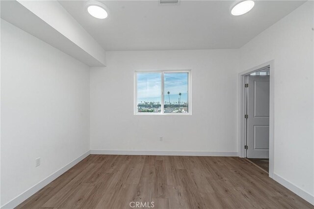 empty room with hardwood / wood-style flooring