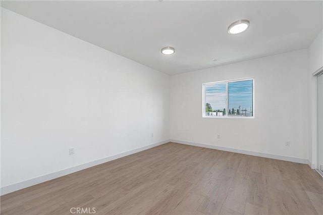 spare room featuring light hardwood / wood-style flooring